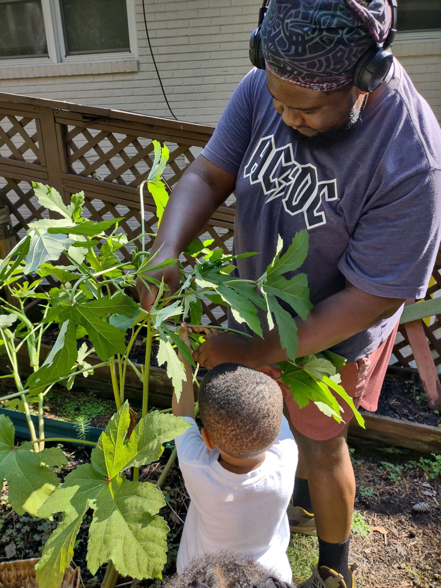 teacher and toddler in garden
